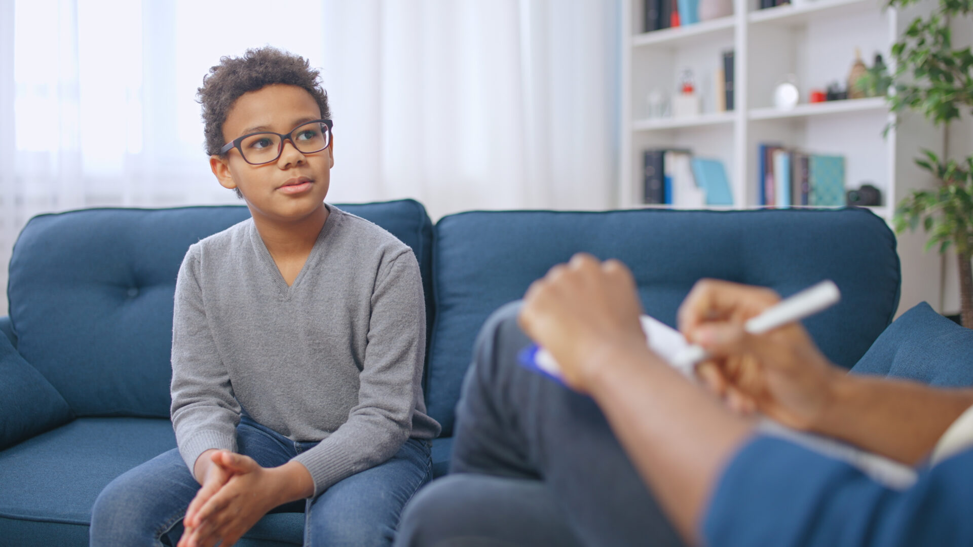 A man sitting on the couch with another person.