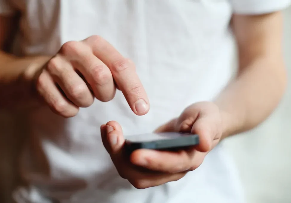 A person holding an electronic device in their hands.